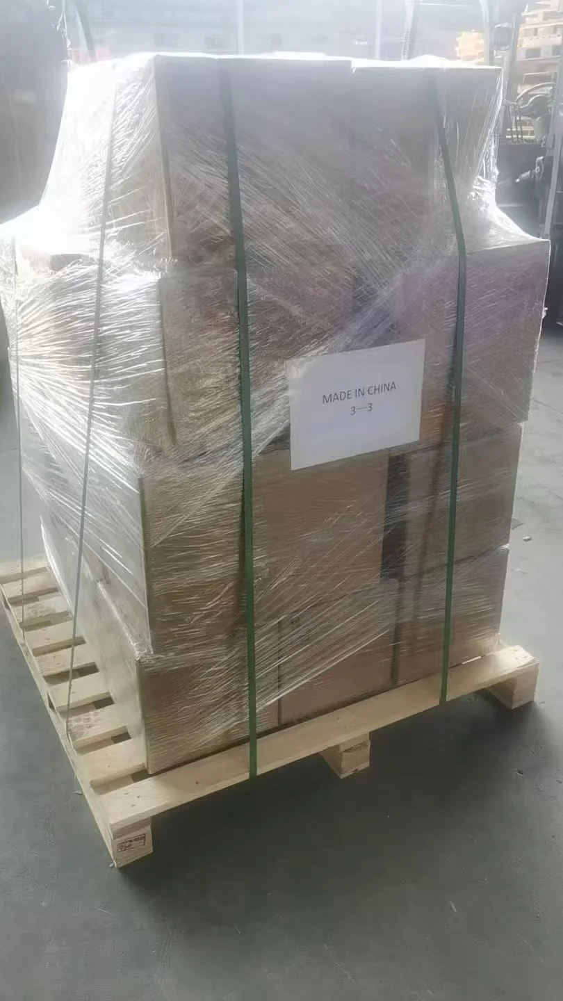 Cardboard cartons secured to a wooden pallet with wrapping film and green straps