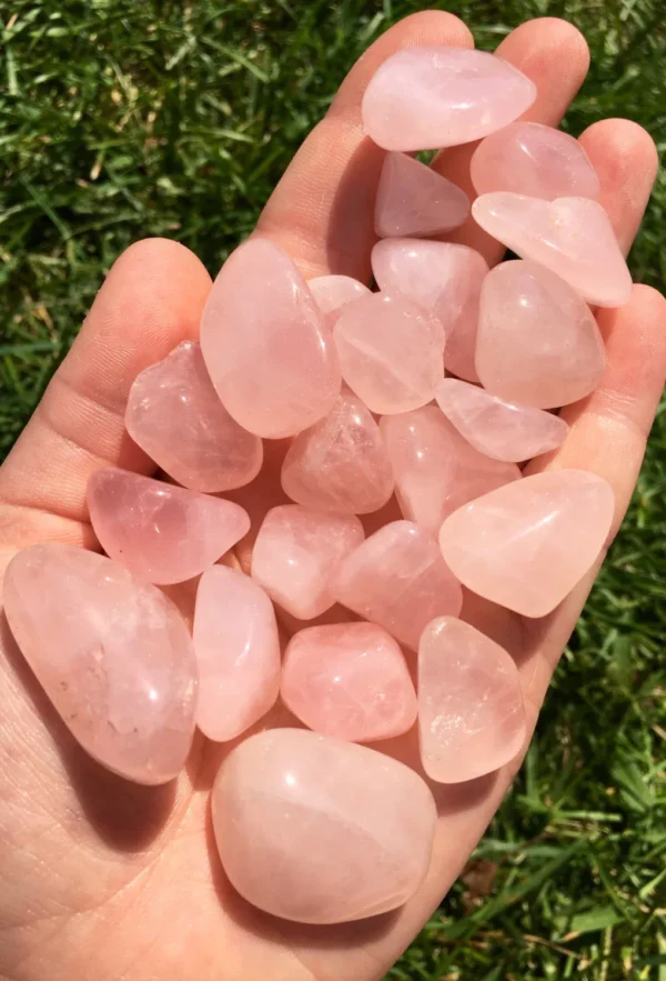 May include: A collection of tumbled rose quartz stones in various sizes and shapes. The stones are a pale pink color and have a smooth, polished finish. May include: A collection of tumbled rose quartz stones in various sizes and shapes. The stones are a pale pink color and have a smooth, polished finish.