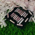 May include: A collection of 24 pink rose quartz crystal points arranged in rows on a black tray. The points are all approximately the same size and shape, and they have a natural, unpolished finish.